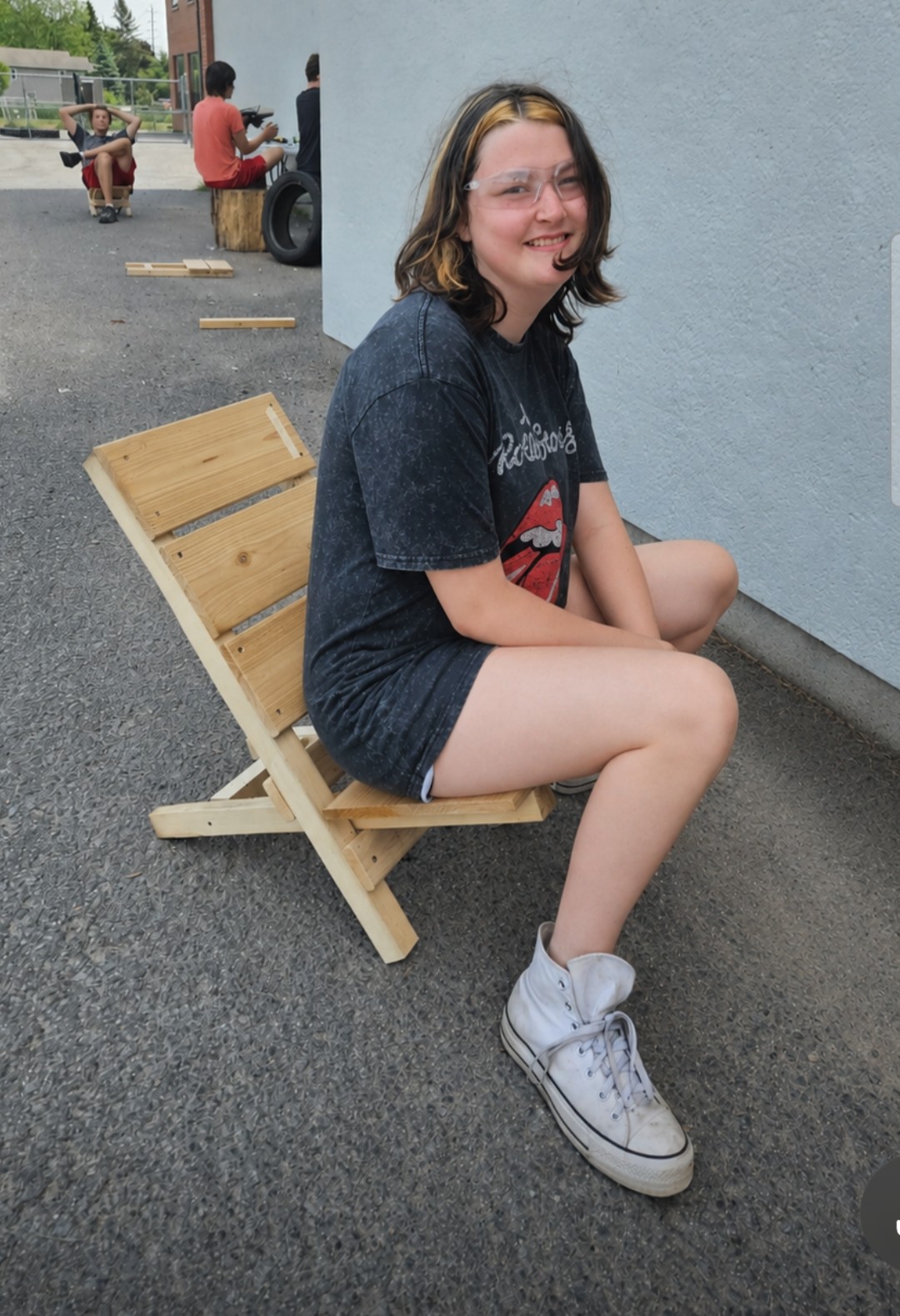 Student sitting on wooden chair